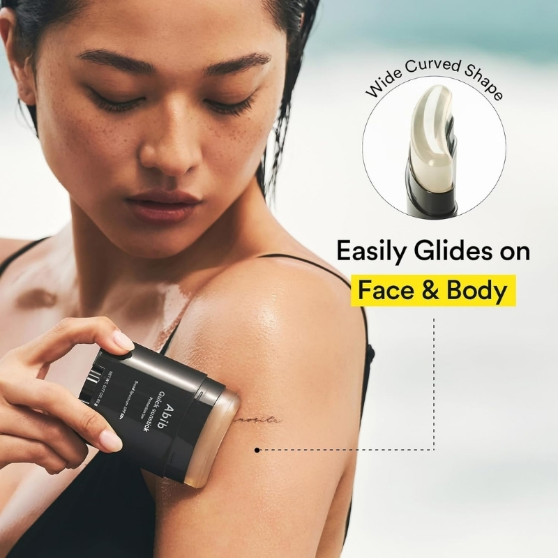 Close-up of a woman applying lotion to her shoulder from a pump bottle; ad claims it easily glides on face and body.