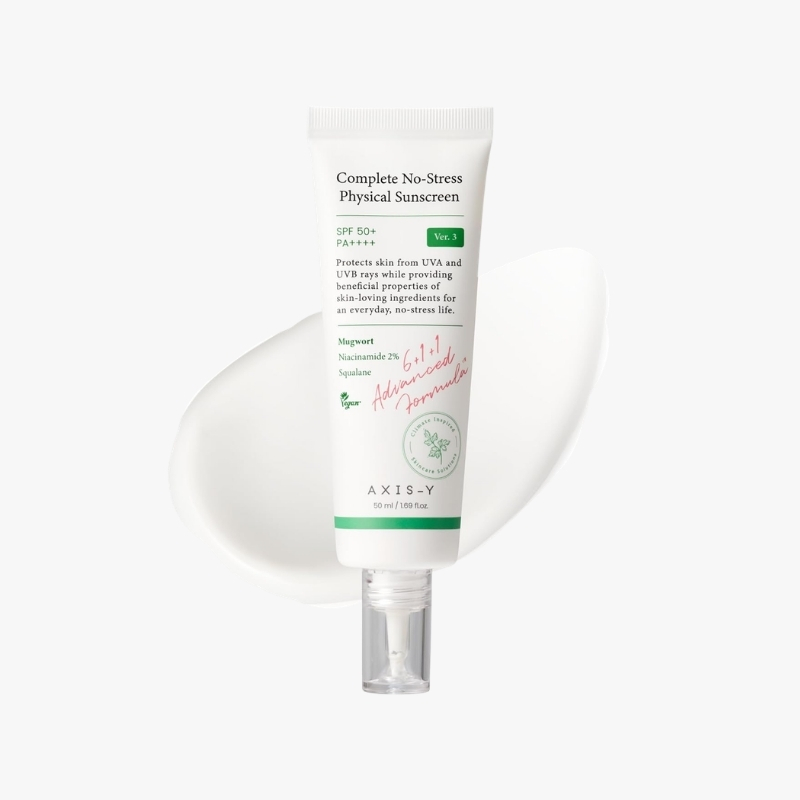 Axis-Y Complete No-Stress Physical Sunscreen tube with SPF 50+ on a white background, showing a smear of sunscreen beside it.