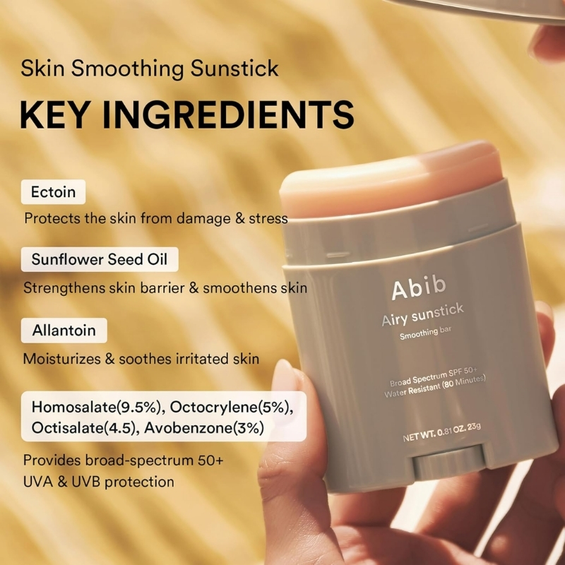 Close-up of a gray Abib Airy Sunstick being held; left side lists key ingredients (Ectoin, Sunflower Seed Oil, Allantoin) and UVA/UVB protection text