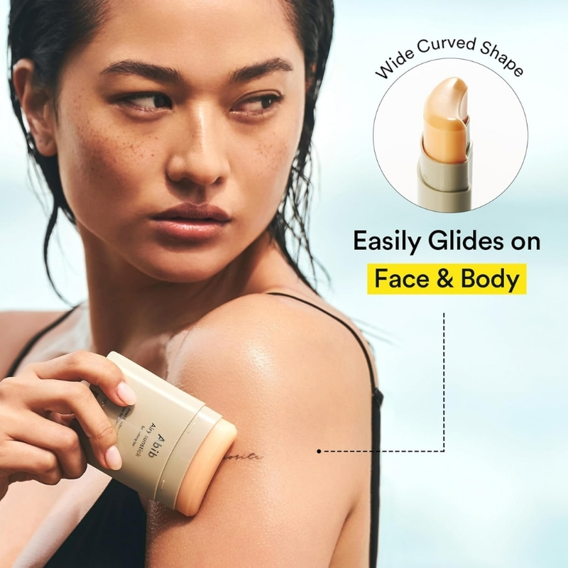 Woman applying lotion from a beige tube to her shoulder; advert text promises easy glide on face and body.