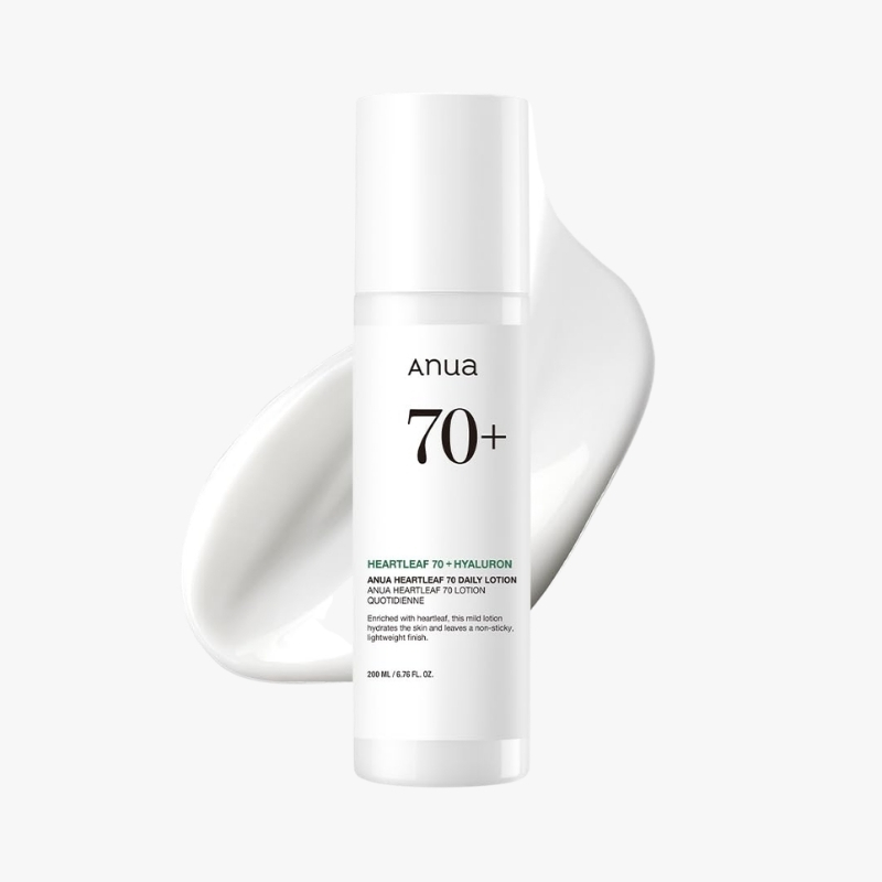 White bottle of Anua 70+ skincare product with heartleaf and hyaluron, cream smear in background, minimalist design