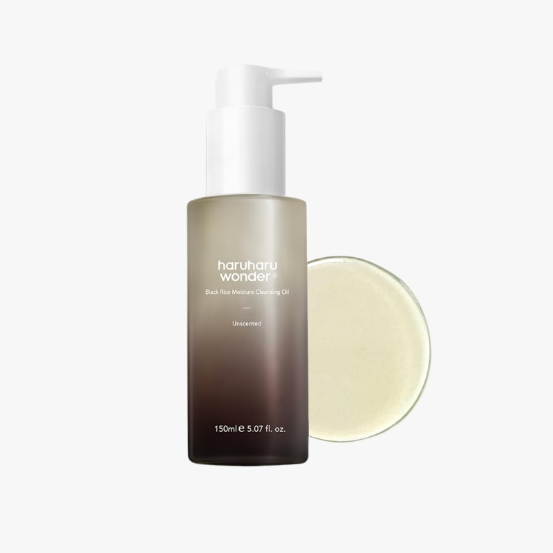 Haruharu Wonder Black Rice Moisture Cleansing Oil bottle with pump, unscented, 150 ml, dark gradient container beside a circular pad/plate