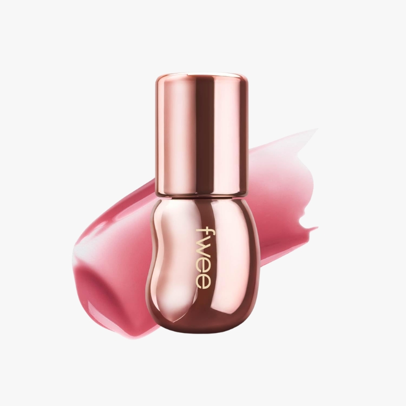 Rose-gold nail polish bottle with pink brushstroke behind it, labeled 'feve' on the front. Ensure brand name visible.