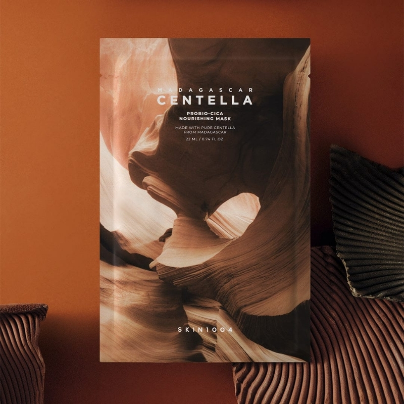 Packaging for a Centella Madagascar nourishing face mask with a desert canyon artwork on a warm orange background.